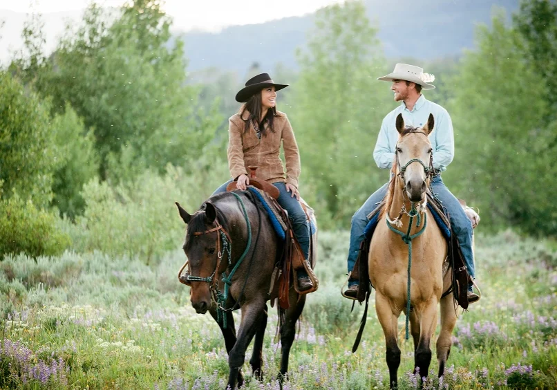 Couple enjoying horseback ride outdoors
